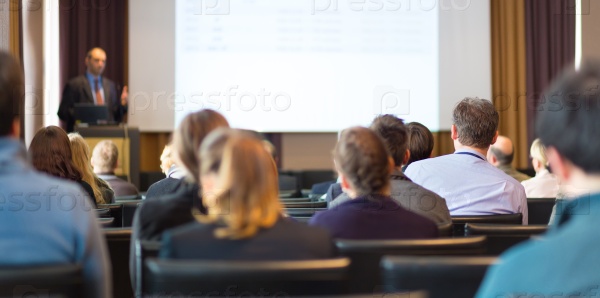 Speaker Giving a Talk at Business Meeting. Audience in the conference hall. Business and Entrepreneurship. Panoramic composition suitable for banners, stock photo