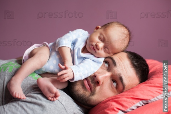 Newborn baby sleeping with father