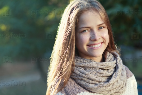 Face of beautiful teen girl in autumn park