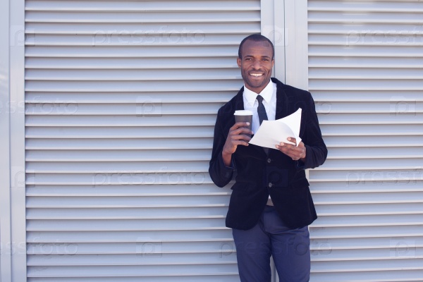 stylish black man documents handling outdoors