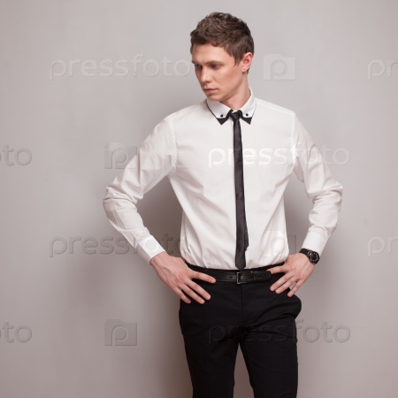 Posing young man model in black and white clothing