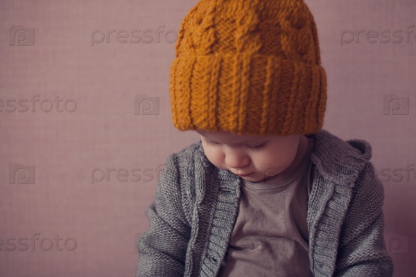 cute kid in knitted mustard color hat