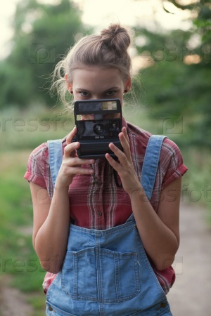 Girl photographer and instant camera