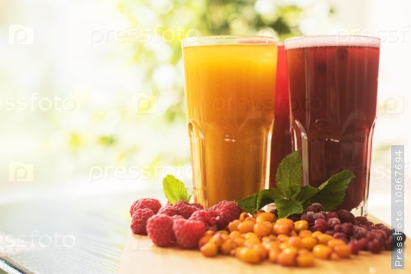 Set of fruit non-alcoholic drink with cranberries raspberries and sea buckthorn, stock photo