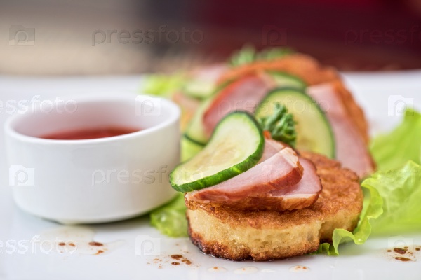 Pancakes with ham and cucumber with tomato sauce and lettuce, stock photo