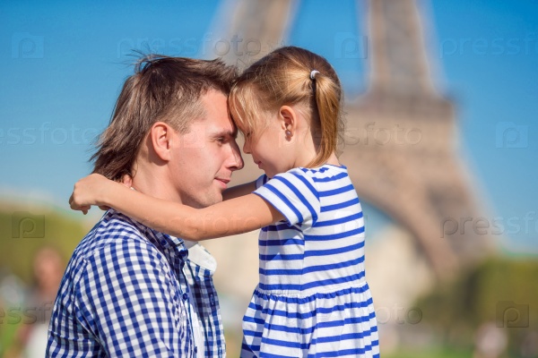 Happy family near Eiffel Tower in Paris, France