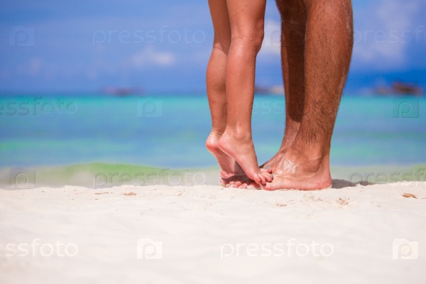 Close up of father and little daughter feet on a tropical beach, stock photo