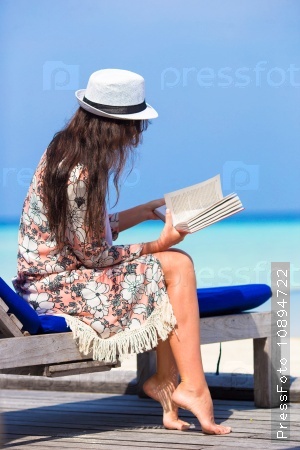 Young woman read book during beach vacation