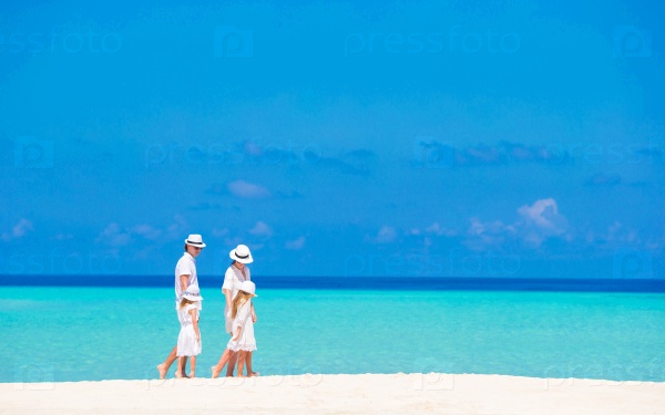 Beautiful tropical beach landscape with family in white enjoying summer vacation