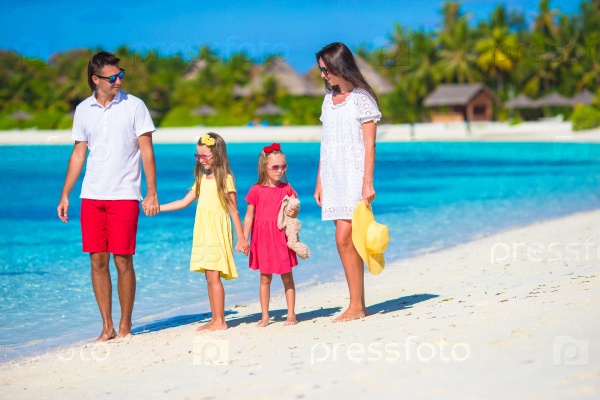 Happy beautiful family vacation on white beach