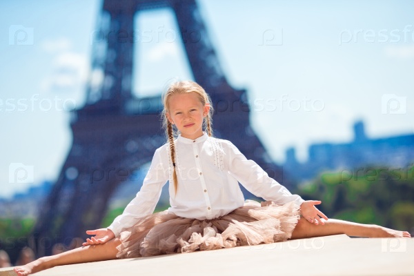 Adorable little girl in Paris background the Eiffel tower in France, stock photo