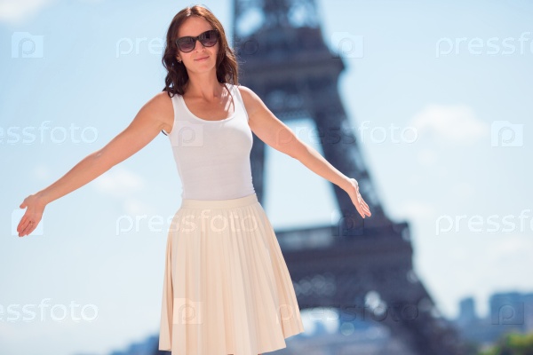 Adorable woman in Paris background the Eiffel tower in France, stock photo