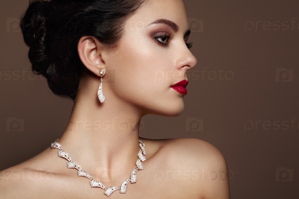 Fashion portrait of young beautiful woman with jewelry. Brunette girl. Perfect make-up. Beauty style woman with diamond accessories, stock photo