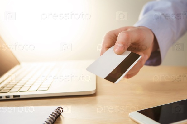 The man doing online shopping with credit card on laptop, stock photo