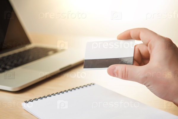 The man doing online shopping with credit card on laptop, stock photo