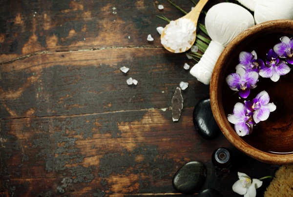 Close up of flowers floating in bowl of water and SPA setting, stock photo