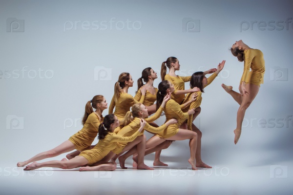 The group of modern ballet dancers dancing on gray background, stock photo