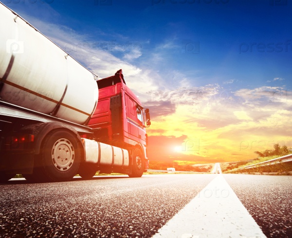 Semi Truck In Motion. Speeding Truck on the Highway. Trucking Business Concept