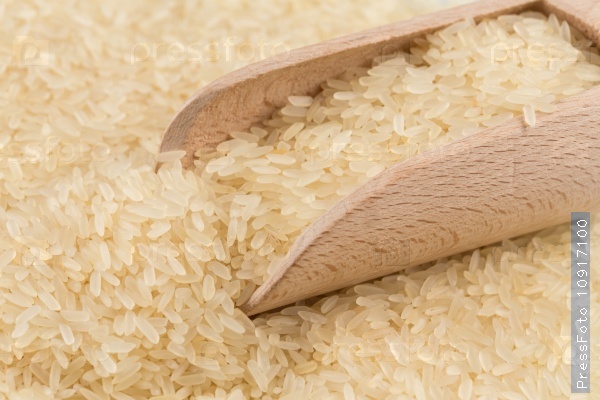 Spoon of rice on puffed rice cereal background close up, stock photo