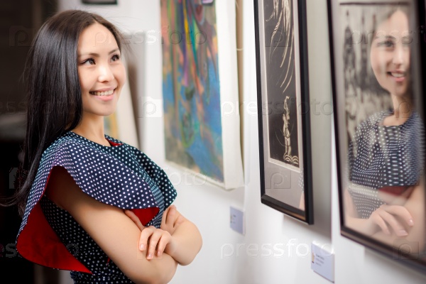Young asian woman as a visitor in the gallery, stock photo