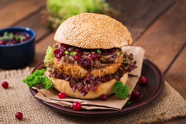 Hamburger with juicy turkey burger with cheese, caramelized onions and cranberry sauce, stock photo