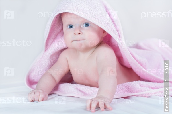 Sweet small baby covered with a towel