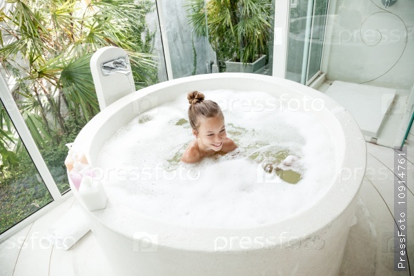 Kid girl washing with a foam in luxury hotel outdoor bath, still life, stock photo
