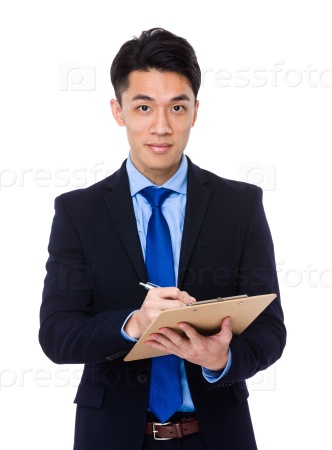 Young businessman take note on clipboard