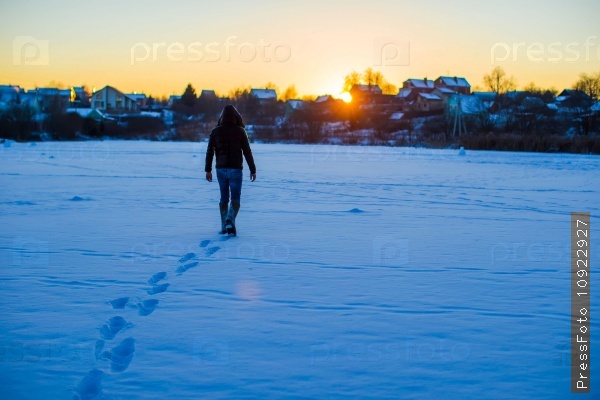 Man walking on deep snowy field
