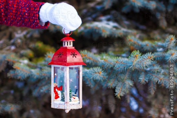 Close up of a hand holding beautiful vintage Christmas lantern