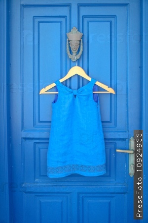Blue dress on blue door in greek house