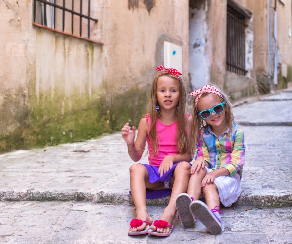 Adorable little girls outdoors in Bonifacio city, Corsica, stock photo