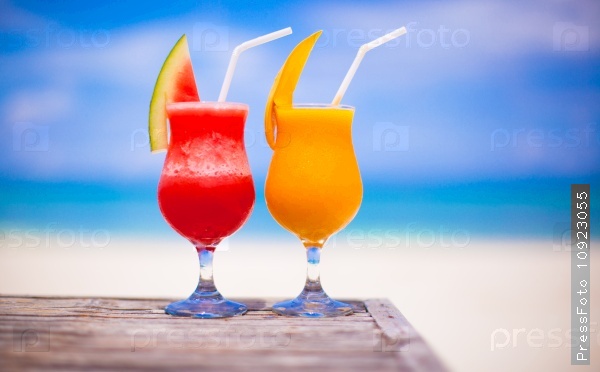 Two cocktails fresh watermelon and mango on background of stunning turquoise sea