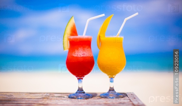Two cocktails fresh watermelon and mango on the background of the stunning turquoise sea, stock photo