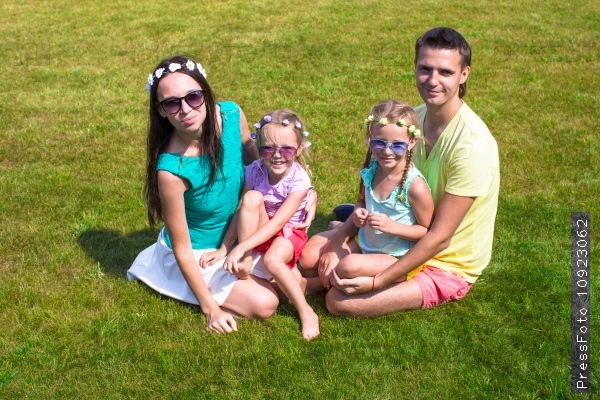 Happy family with two children outdoors on summer day