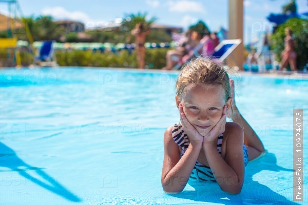 Little girl at aquapark during summer vacation, stock photo