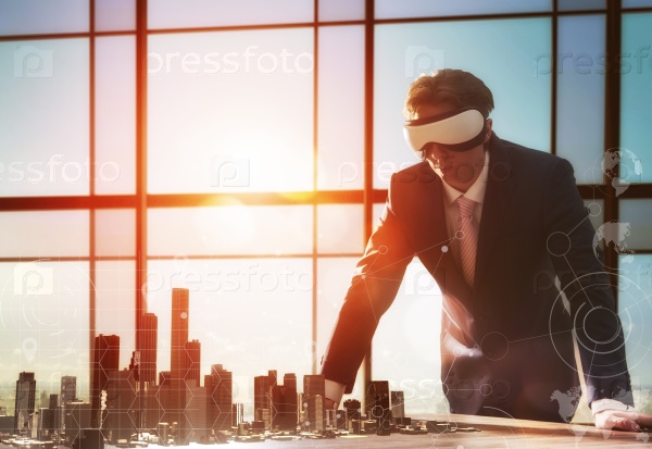 Businessman developing a project using virtual reality goggles. the concept of technologies of the future, stock photo