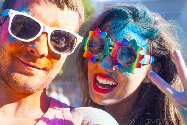 Portrait of happy couple in love on holi color festival