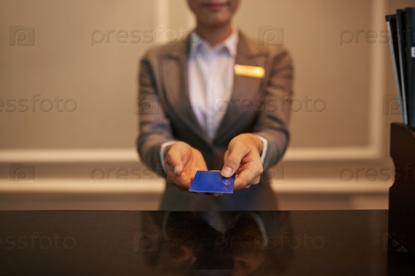Hands of receptionist giving smart card to you