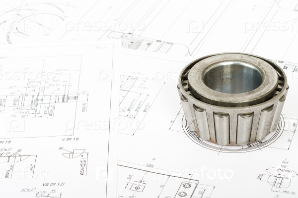 Roller bearing on blue prints, close up view, stock photo
