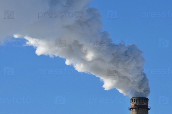 Industrial smoke from chimney on blue sky day, stock photo