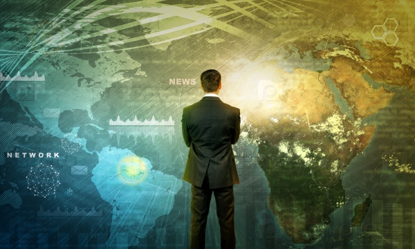 Businessman in front of world map with graphical charts, business concept, stock photo