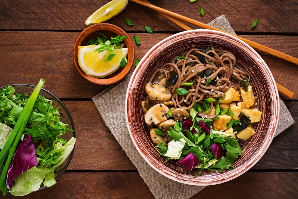 Miso and soba noodle soup with roasted  tofu and  mushrooms. Top view