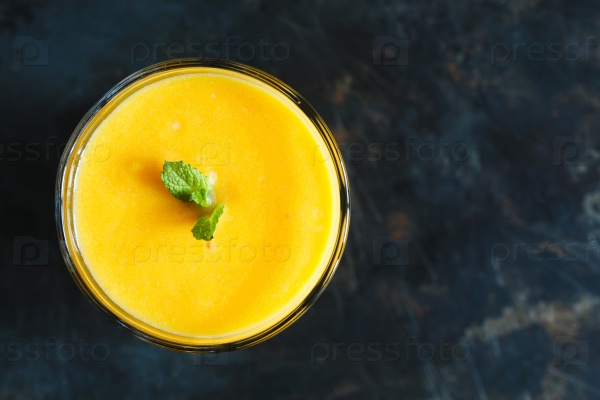 Orange smoothie with mint in the glass, top view, stock photo
