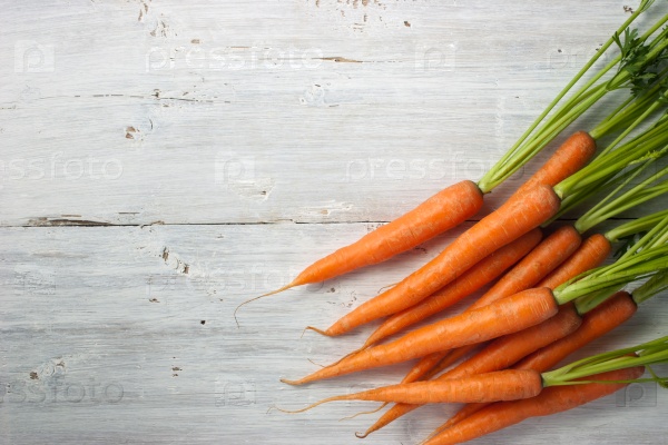 Carrots on the white wooden table horizontal
