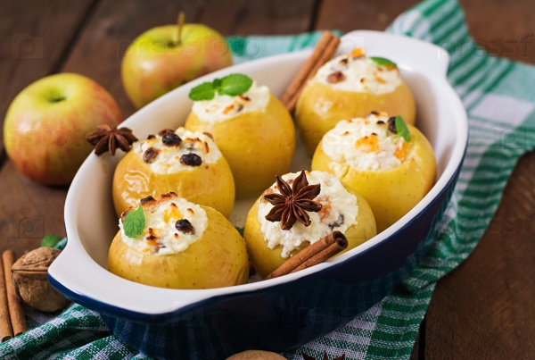 Appetizing baked apples with cottage cheese and raisins, stock photo