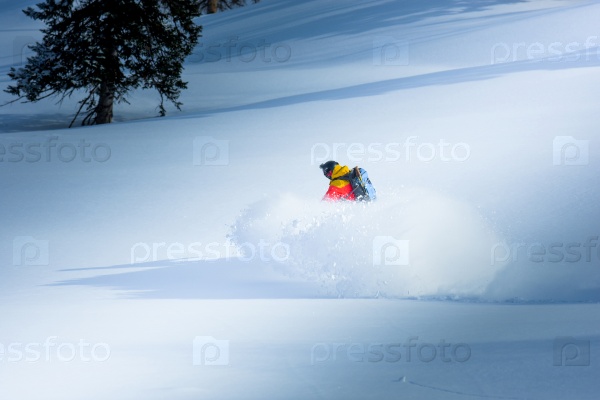 Snowboarder going down the hill on the winter, stock photo