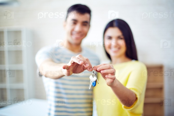 New settlers holding keys from their flat, stock photo