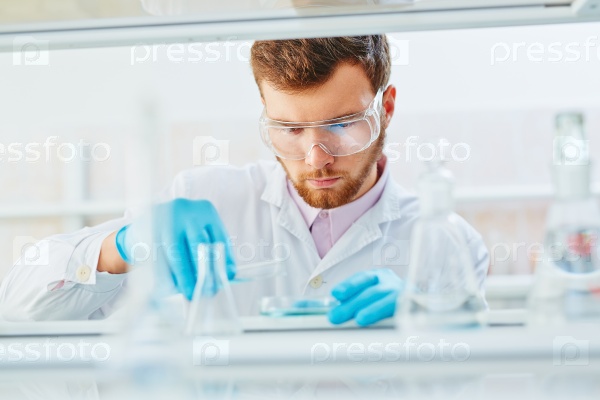 Lab technician doing experiment in lab, stock photo