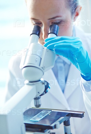 Woman in laboratory working with a microscope